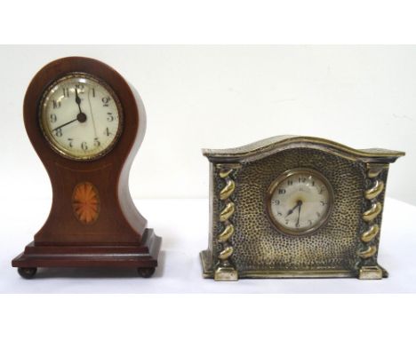 ART DECO MANTLE CLOCKin a shaped hammered brass case with a circular silvered dial with Arabic numerals and a thirty hour mov