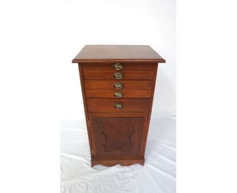 EDWARDIAN STYLE STAINED WOOD MUSIC CABINETwith five graduated drawers above a single door compartment with shelf interior, ra