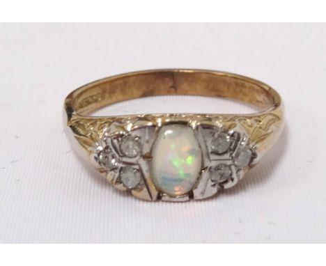 OPAL AND DIAMOND RINGthe central oval cabochon opal flanked by three diamonds to each shoulder, on nine carat gold shank, rin