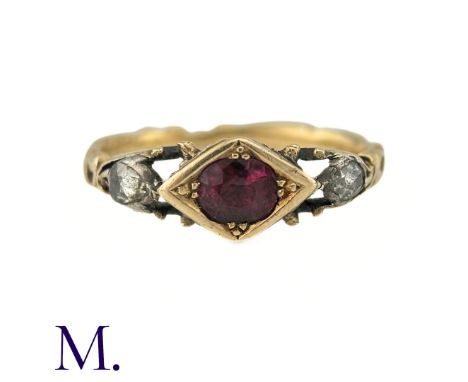 A Georgian Ruby And Diamond Three Stone Ring in yellow gold, the central cushion cut ruby flanked either side by rose cut dia