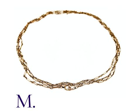 An Antique Longuard Chain in 9k yellow gold, the long guard chain comprising a series of fancy links terminating with a large
