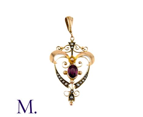 An Antique Garnet and Pearl Pendant in 9k yellow gold, set with a principal oval cut garnet accented by scrolling motifs set 