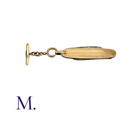 An Antique Folding Pen Knife in yellow gold and metal, the striped body with blank shield design. with folding knife and pipe