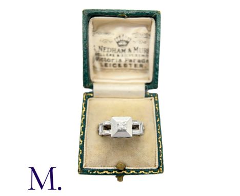 A Diamond Ring in 18K white gold set with 0.10ct centre, together with approximately 0.40ct baguette cut diamonds in surround