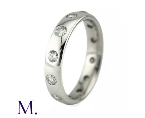 A Diamond Eternity Ring in 18k white gold, the band set with twelve round brilliant cut diamonds totalling approximately 0.85