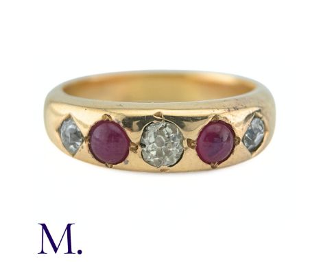 A Ruby And Diamond Gypsy Ring in yellow gold, set with three old cut diamonds punctuated by two cabochon rubies. (Unmarked bu