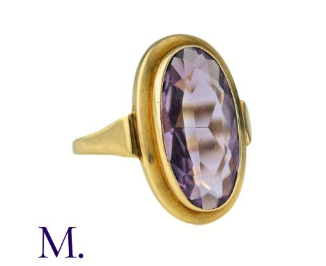 An Amethyst Ring in 14k yellow gold, set with a large elongated oval cut amethyst of approximately 6.0cts. Stamped 585 for 15