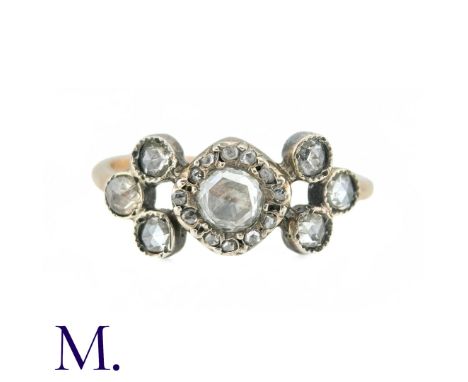 An Antique Diamond Ring in yellow gold and silver the principal rose cut diamond surrounded by a border of further rose cut d