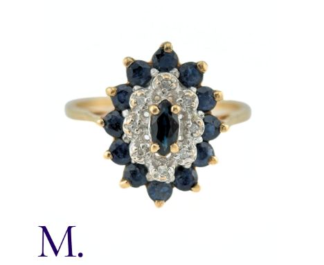 A Sapphire and Diamond Ring in 9k yellow gold, the central marquise cut sapphire surrounded by a border of round cut diamonds