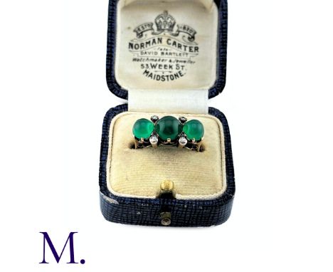 An Antique Chrysoprase and Diamond Ring in 18K yellow gold. Set with three cabochon chrysoprase stones and four small accent 
