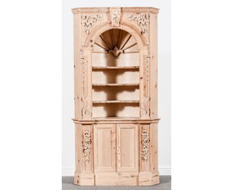 A pair of George II style pine freestanding corner cabinets, 20th Century, the upper sections with open arches, curved backed