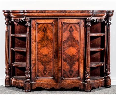 A Victorian figured walnut credenza, shaped breakfront form, moulded frieze, two panel doors to the centre section enclosing 