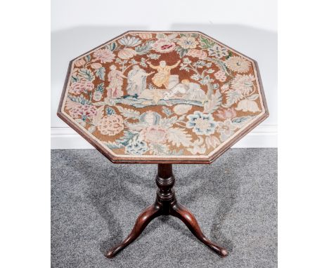 A George III mahogany pedestal table, adapted as a screen, octagonal tilt top with a later needlework panel depicting the Res