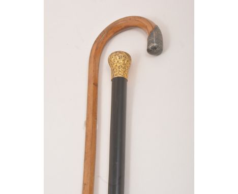 A light wood walking stick, with a silver terminal, London 1923, engine turned decoration, 93cm and an ebony walking cane, gi