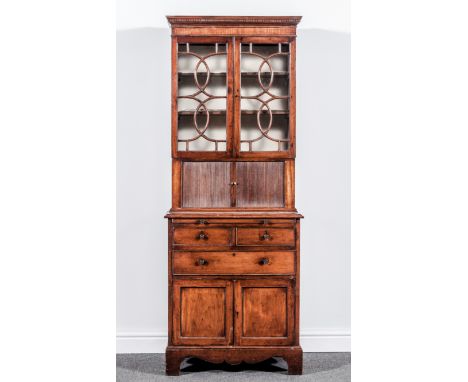 A Regency style mahogany bookcase cabinet, of small proportions, dentil cornice, plain frieze, astragal glazing bars to the t
