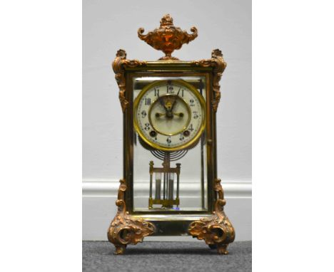 An American lacquered brass and electro-copper four glass table clock, Ansonia, New York, rococo style urn finial and with Ro