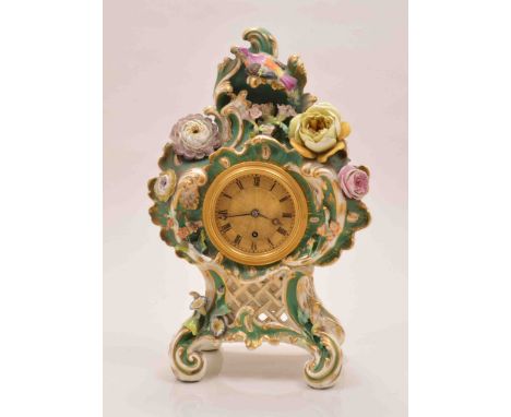 Vulliamy, London, 1153
Rockingham style porcelain mantel clock, scrolled Rococo design encrusted with flowers, engine turned 