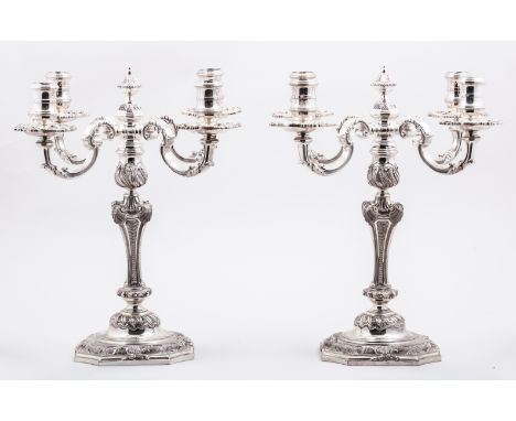 A pair of George II style silver four light candelabra, Asprey & Co., London 1974, after a design by Paul de Lamerie, the fou