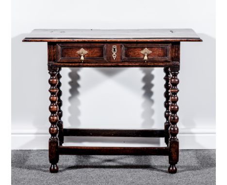 A joined oak side table, 18th Century, rectangular top with a moulded edge, fitted with a single frieze drawer with recessed 