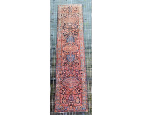 Persian runner, dark blue ground with three medallions and stylised flowers, light blue floral border, 532 x 118cms.
