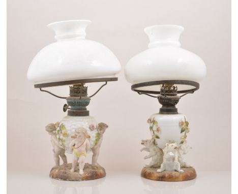 A German porcelain lamp base, Sitzendorf, circa 1900, ovoid reservoir encrusted with rose sprigs, supported by three polar be