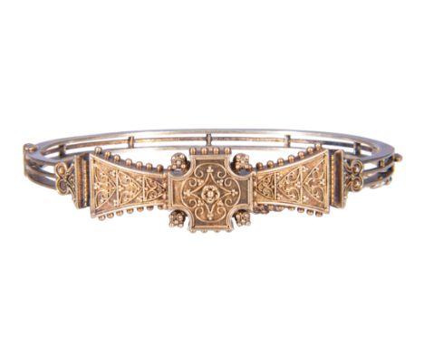A Victorian yellow metal half hinged Etruscan style bangle, with wire and bead work decoration to the front, frost gilded, wi
