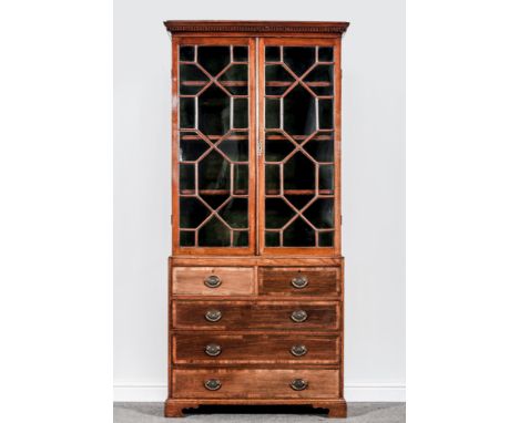 A George III style mahogany bookcase, adapted, moulded and dentil cornice, two astragal glazed panel doors to the upper secti