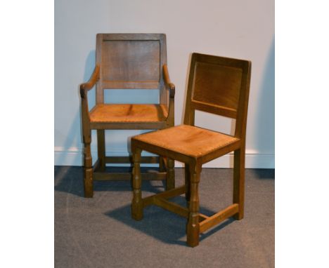 An Arts & Crafts oak elbow chair, by Robert "Mouseman" Thompson of Kilburn, probably 1950's, panelled back, open arms, studde