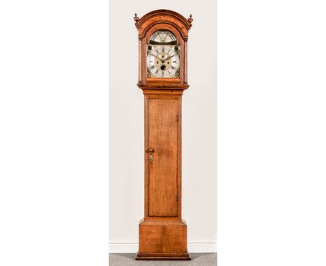 An oak longcase clock, arched brass dial, silvered chapter ring with Roman numerals and Arabic minute divisions, three supple