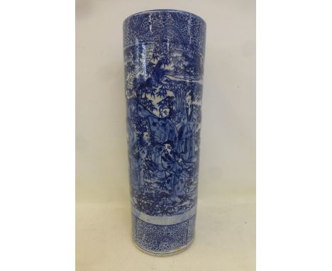 An Oriental blue and white cylindrical stick stand.