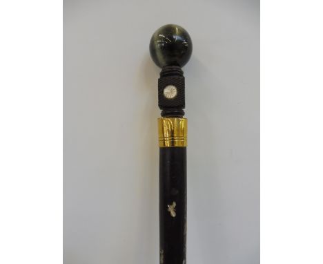 A walking stick with a decorative shaft and ball knop.