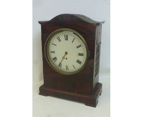 A George III mahogany cased bracket clock with a circular dial, brass pierced grill sides and a twin fusee movement. 