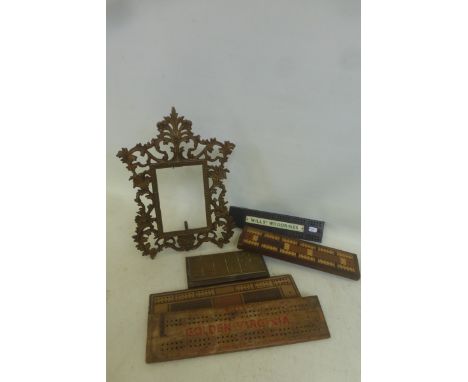 A good quality brass photograph frame and five cribbage boards, including one brass example.