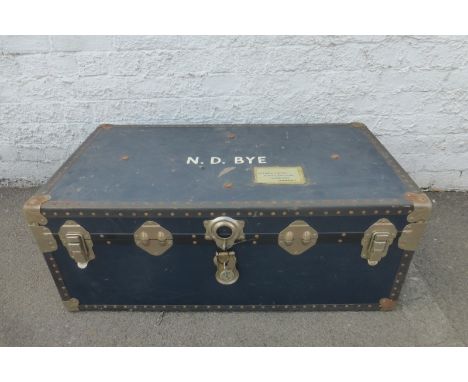 A large metal bound travel trunk. 
