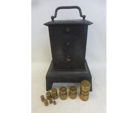 An unusual cast iron clockwork grinder and a small quantity of brass weights.