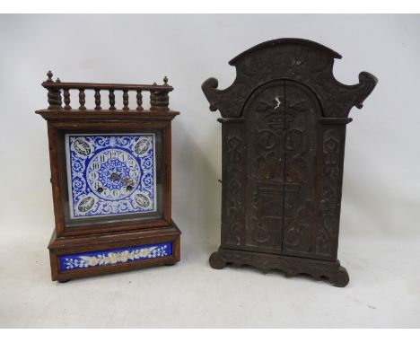 A late 19th Century oak cased mantle clock with a blue and white enamel dial, plus an unusual single door cupboard of ecclesi