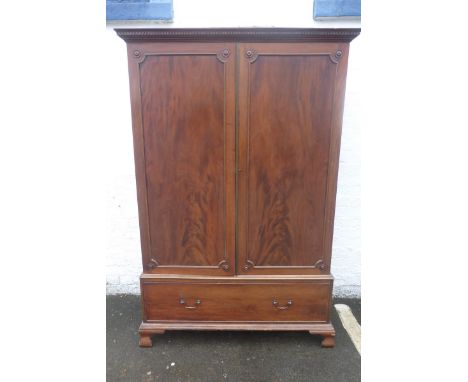 A 19th Century mahogany two door hanging wardrobe raised upon a single drawer base to ogee bracket feet.