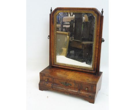 An 18th Century walnut dressing table mirror with three swept drawers to bracket feet. 