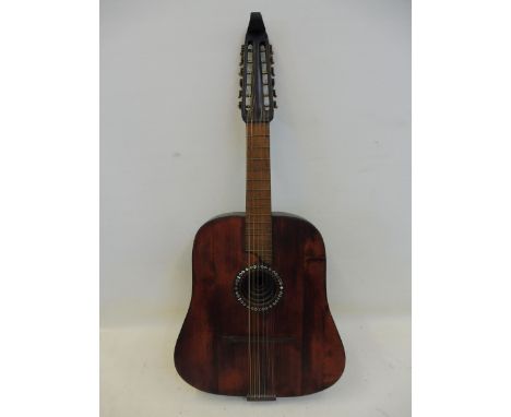 An unusual short scale 12 string guitar or maybe a Spanish laud, mid 20th Century, string playing length 74cm, overall 86cm.