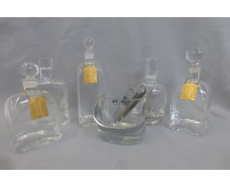 An Orrefors heavy glass ice bucket and tongs and five Dartington and other glass decanters. 