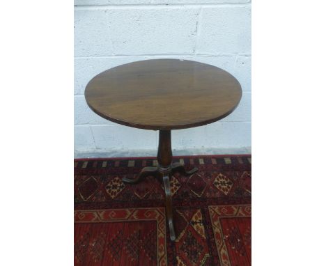 An 18th Century oak tilt top tripod table.