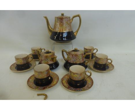 A good quality Japanese Satsuma part tea set comprising tea pot, sugar bowl, cream jug and six cups and saucers, signed under