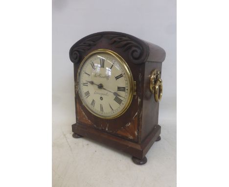 A Regency mahogany bracket clock with acanthus carved decoration and satinwood fan inlay, surrounding a circular dial marked 