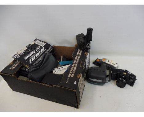 A cased Nikon camera, with lenses and various other cameras.