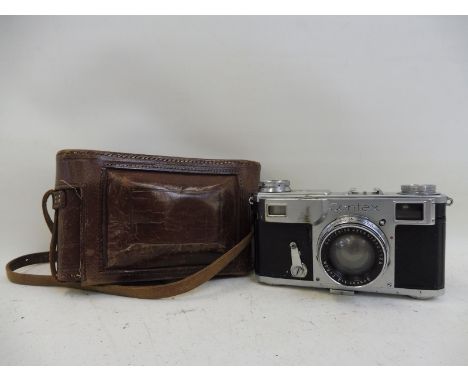 A leather cased Contax camera.