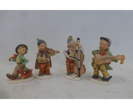 A set of three early Friedel, Germany Handgemalt figures, all musicians and a Goebel figure 'Strolling Along'.