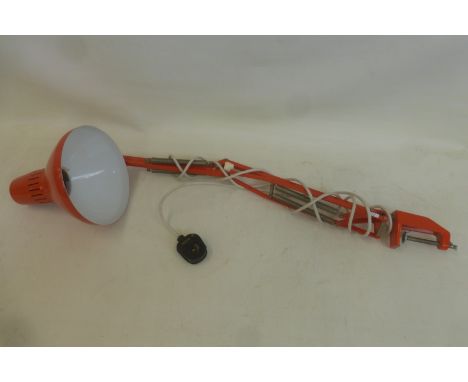 A 1960s adjustable study lamp with clamp, in bright orange livery, bearing a label for Waso Ledu Type WH.