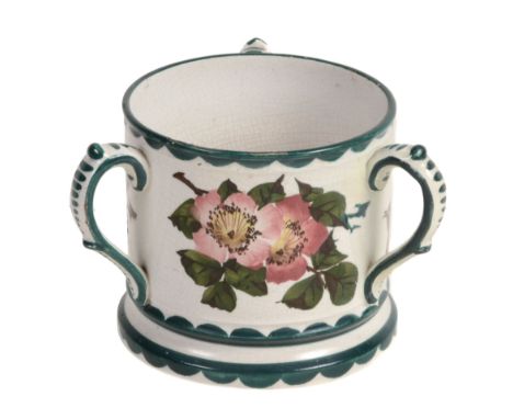 A Wemyss loving cup or tyg, circa 1900, painted with wild roses  A Wemyss loving cup or tyg, circa 1900,   painted with wild 