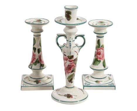 A pair of Wemyss candlesticks, circa 1910, painted with pink roses  A pair of Wemyss candlesticks, circa 1910,   painted with