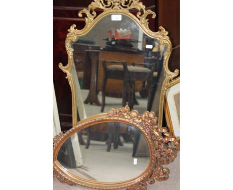 OVAL FRAMED WALL MIRROR AND A WALNUT CASED MANTEL CLOCK